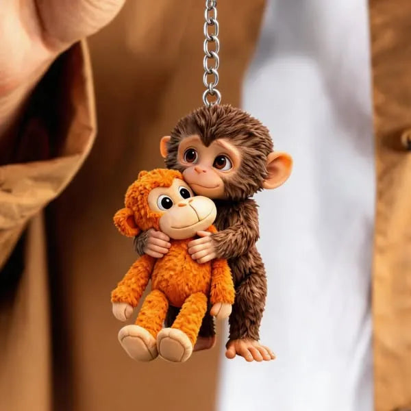 Söpö apina-avaimenperä pehmohahmolla
